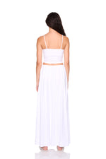Woman wearing a white dress with thin straps on a white background