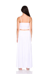 Woman wearing a white dress with thin straps on a white background