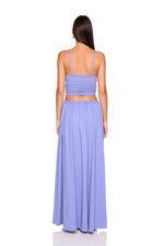 Woman wearing a light purple two-piece dress on a white background