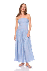 Woman wearing a blue striped strapless dress on a white background