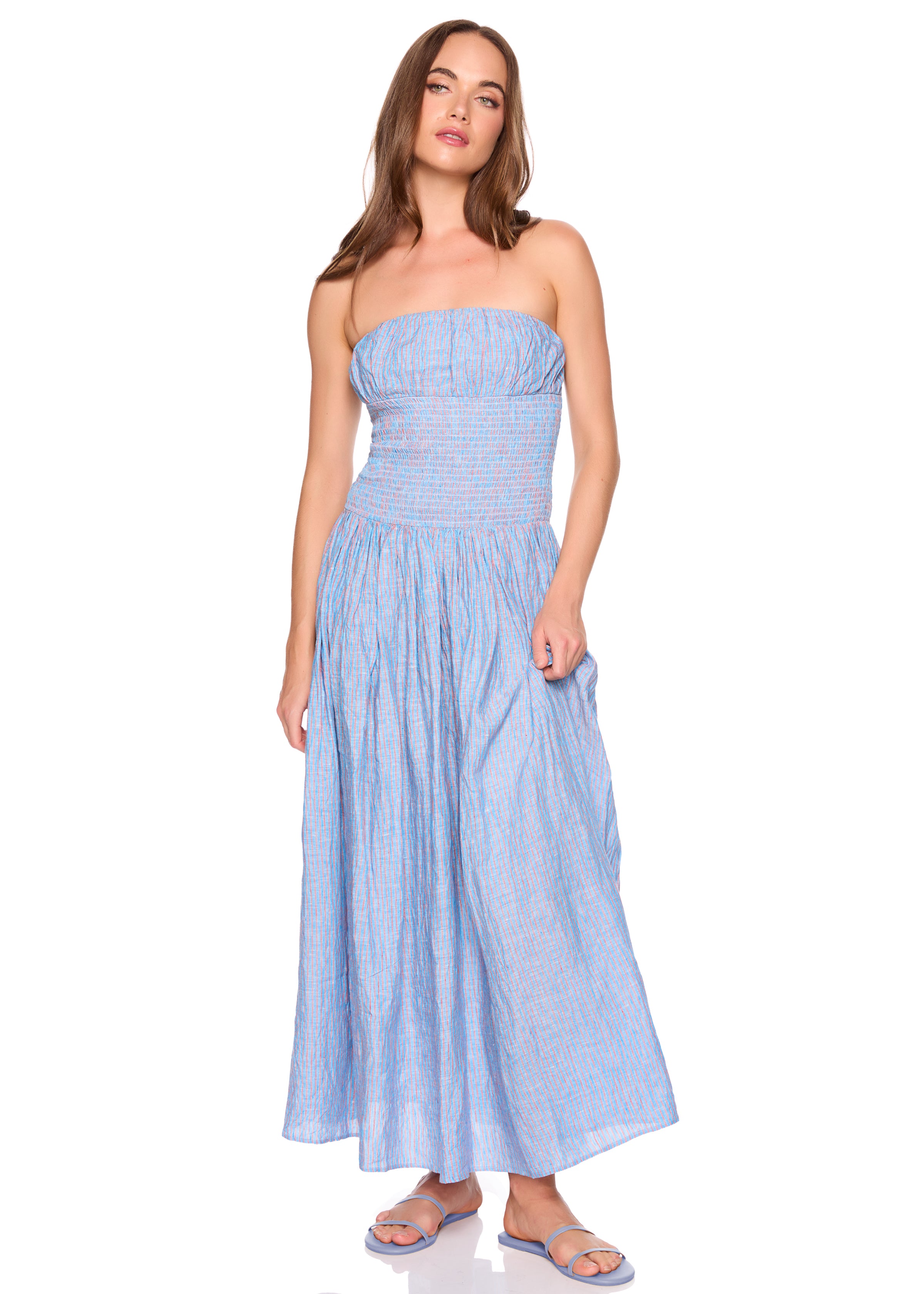 Woman wearing a blue striped strapless dress on a white background