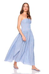 Woman wearing a blue strapless dress on a white background