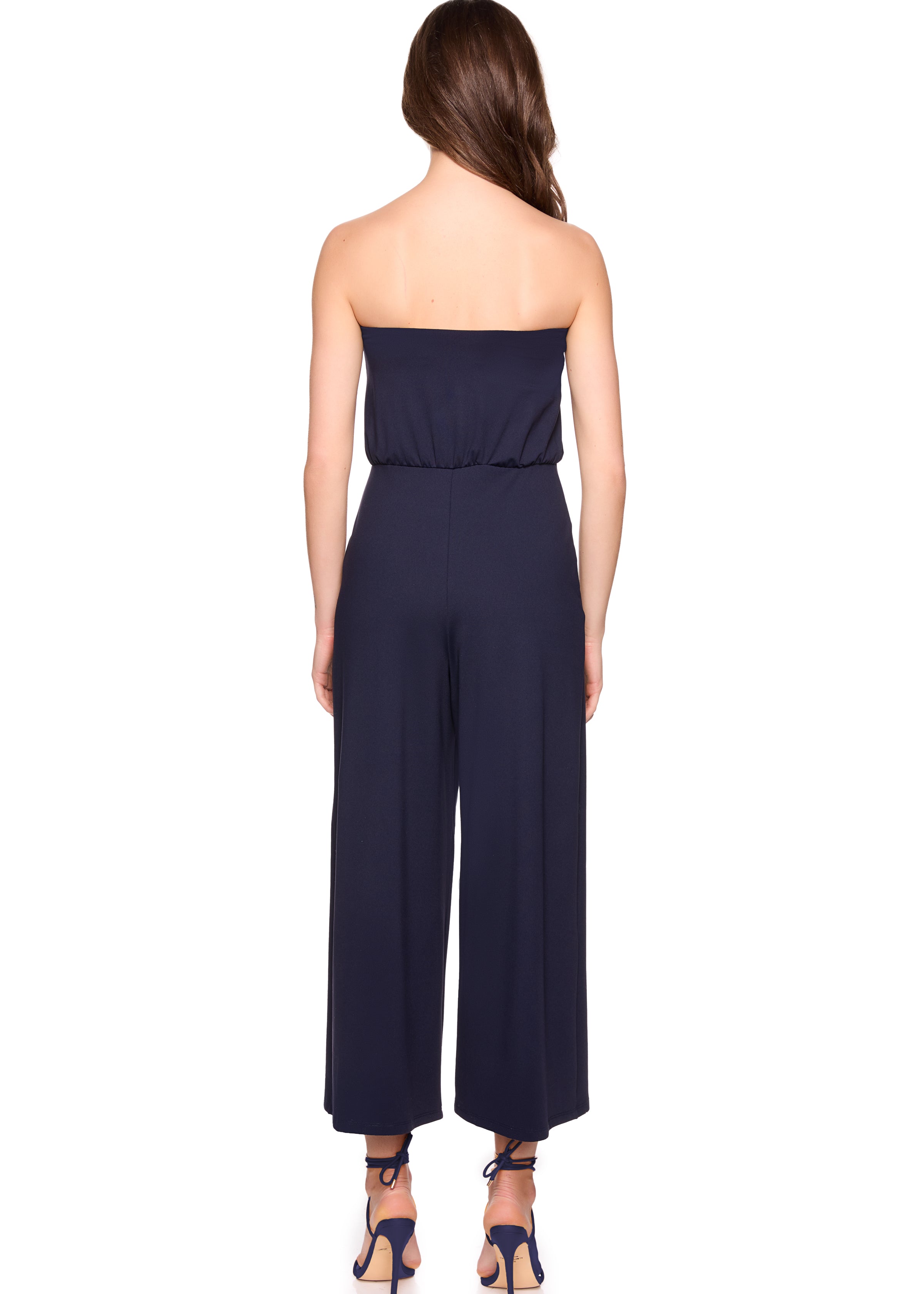 Navy strapless jumpsuit worn by a model on a white background