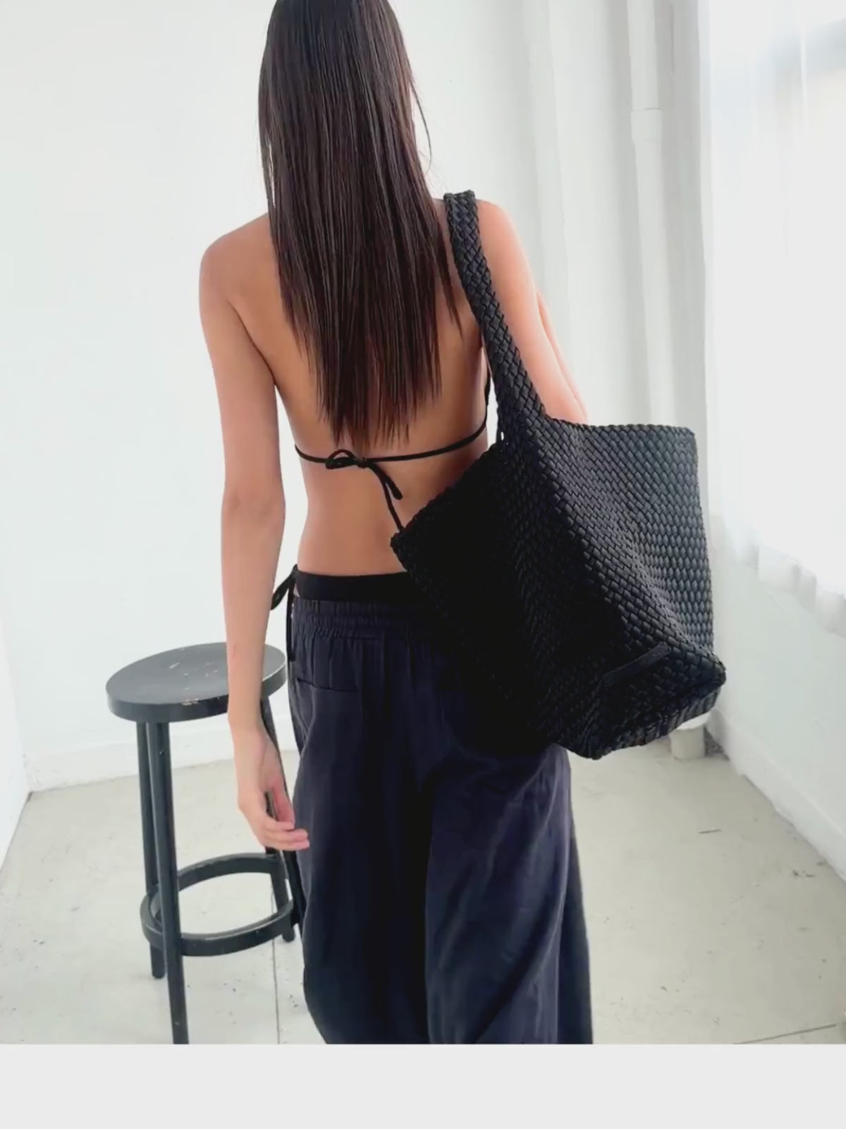 This image features a stylish hobo shoulder bag that is paired with a matching zipper pouch, enhancing its functionality. The tote is crafted from a neoprene material, which is known for its durability and water-resistant properties, making it ideal for beach days or casual outings.